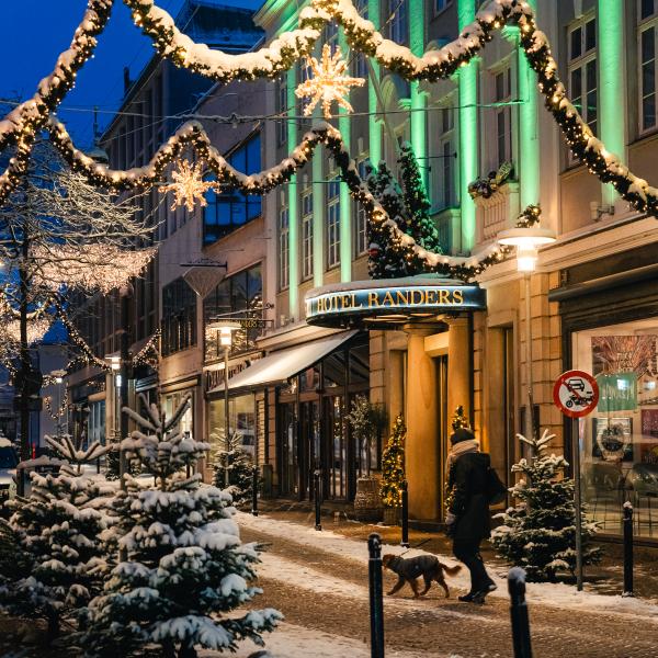 Mand med hund går gennem julebyen Randers